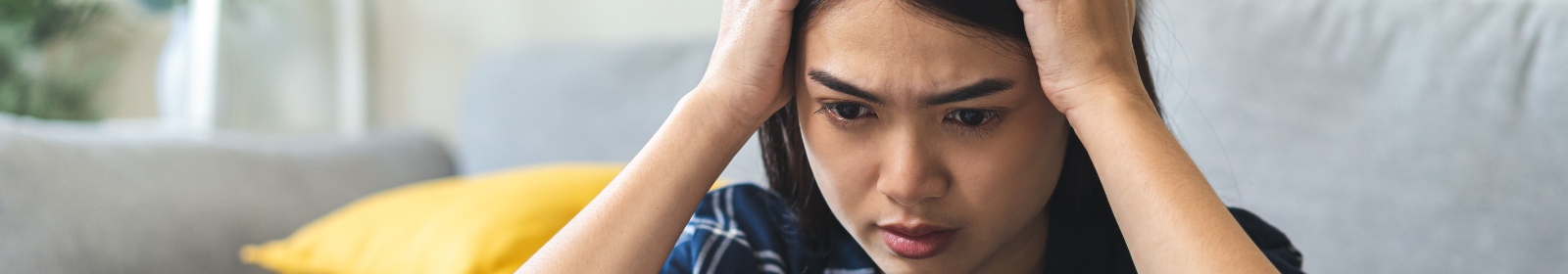 a woman with hands on her head in stress